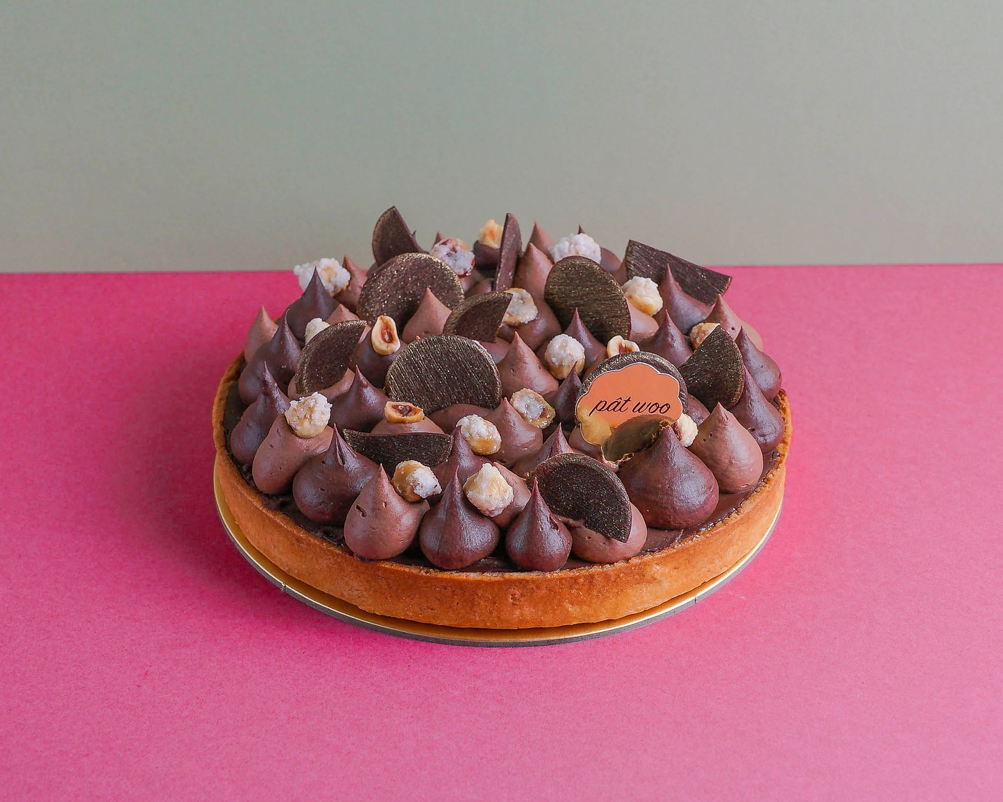 Layered tart with a buttery pastry crust filled with smooth chocolate ganache, crunchy chocolate wafer and soft hazelnut sponge cake. Ttopped with whipped chocolate cream and toasted hazelnuts.