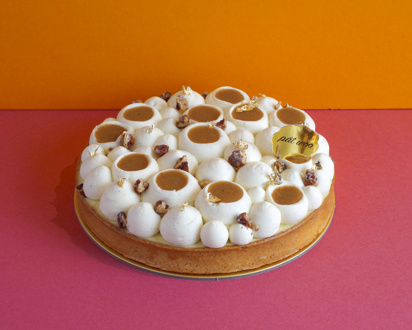 Vanilla ganache, pecan wafer, almond sponge, and caramelised pecans sit atop a tart crust. Topped with chunks of pecans.